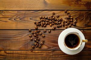 Overhead view of a cup of coffee on a wooden table. Close up overhead view of a cup of strong frothy espresso and coffee beans on a textured wooden surface. copyspace for your text photo