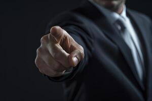 A man in a suit pointing at something photo