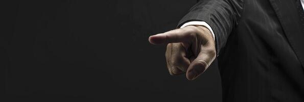 A man in a suit pointing at something photo