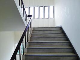 Pathway of stairway or staircase inside the building with white light from window. Interior structure design concept photo