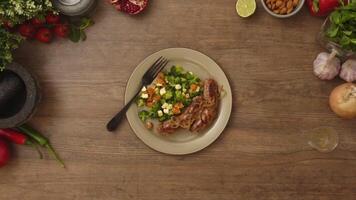 Overhead view of person putting fork on plate with salad and sausages video