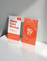 Two name card mockups display a clean design with an orange and white color scheme psd