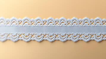 Close-up of delicate white lace ribbon on a soft golden background, showcasing intricate details photo
