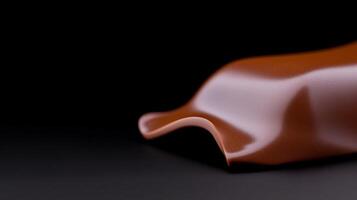 Smooth, glossy chocolate wave on a dark background, showcasing texture and sheen for culinary use photo