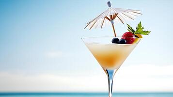 Refreshing cocktail with a decorative umbrella and fruits on a beach with a clear sky photo