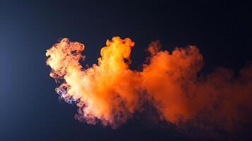 Vibrant orange smoke swirling against a dark background, creating an artistic visual effect photo