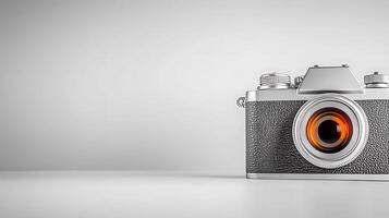 Vintage camera on a minimalist background, showcasing its design and lens, perfect for photography themes photo