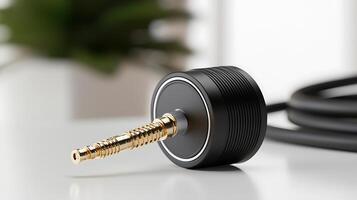 Close-up of a sleek audio connector on a table with a blurred plant in the background photo
