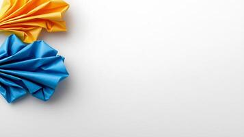 Colorful paper folds in blue and yellow on a white background, creating a vibrant design photo