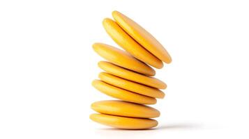 Stacked yellow disks balanced precariously on a white surface, showcasing a minimalist design photo