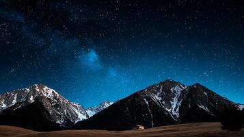 Starry night over snow-capped mountains with a serene cabin in the foreground, tranquil atmosphere photo