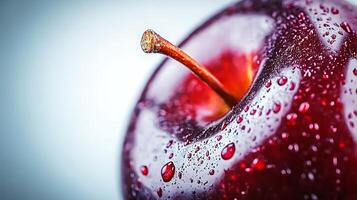 Close-up of a fresh, dewy red apple with droplets, showcasing its vibrant color and texture photo