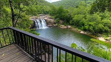 Serene waterfall cascading into a tranquil pool surrounded by lush greenery and mountains 1 photo