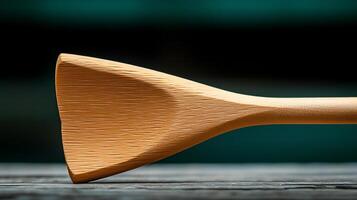 Close-up of a wooden cooking spoon resting on a rustic table with a blurred background photo