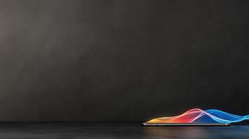 A sleek smartphone displaying vibrant soundwave graphics on a dark textured background photo