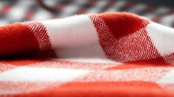 Close-up of a textured red and white checkered fabric draped softly on a surface photo