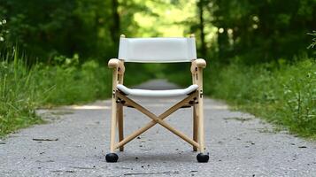 A minimalist folding chair positioned on a serene forest path surrounded by lush greenery photo