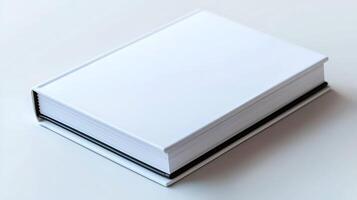 A plain, closed book resting on a smooth surface, showcasing its simple design and texture photo