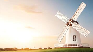 A picturesque windmill stands against a sunset sky, surrounded by green fields, symbolizing tranquility photo