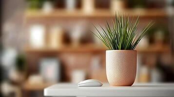 A modern workspace featuring a potted plant beside a computer mouse on a white table photo