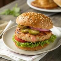 A hamburger with pickles and onions on a plate photo