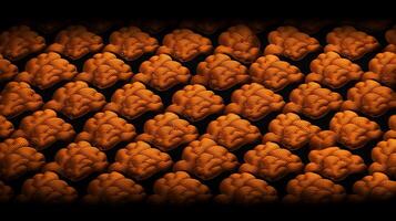 A vibrant pattern of orange brain-shaped objects arranged in a grid on a dark background photo