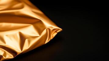 Close-up of a crumpled golden fabric against a dark background, showcasing texture and sheen photo