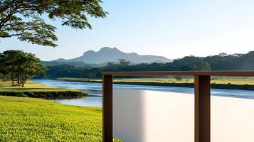 Scenic view of a river with mountains in the background, framed by a wooden railing at sunrise photo