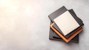 Stacked notebooks on a textured surface with soft lighting, ideal for creative workspace themes photo
