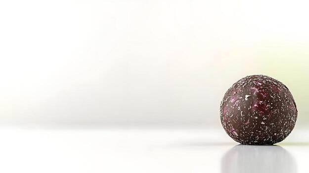 A close-up of a textured chocolate truffle resting on a smooth surface with a soft background photo