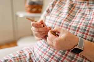 Close-up view of hands of an senior woman crocheting. photo