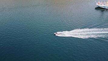 Aerial view of a motorboat proceeding at high speed, ploughing through the sea and leaving a wake behind video