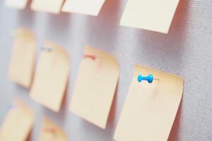 Sticky notes on a bulletin board with pin photo