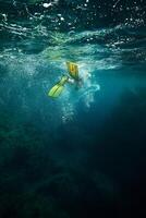 Diver swimming under water in flippers photo
