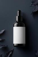 Black dropper bottle mockup with blank label and black leaves on dark background photo