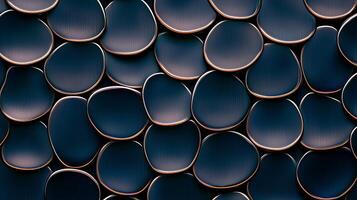Abstract close-up of dark, glossy rounded shapes with golden edges, creating a textured pattern photo