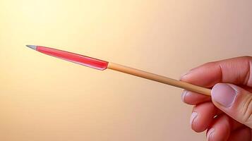 Close-up of a hand holding a colorful pen against a soft gradient background photo