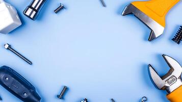 A collection of various hand tools and hardware items arranged on a blue background photo