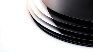 Close-up view of layered black and white plates creating a sleek, modern aesthetic on a clean surface photo