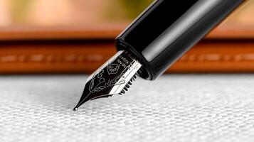 Close-up of a fountain pen poised to write on textured fabric, with a blurred background photo