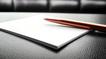 Close-up of a shiny pen resting on a blank notepad atop a sleek black surface, suggesting creativity photo
