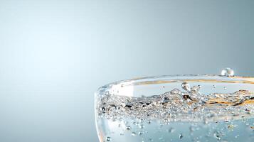 Close-up of a glass filled with water, showcasing splashes and bubbles against a soft background photo