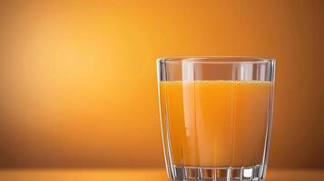 A refreshing glass of orange juice sits on a vibrant orange background, perfect for summer vibes photo