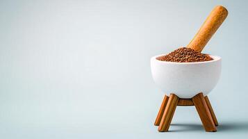 A wooden mortar and pestle filled with spices on a minimalistic background, perfect for cooking photo