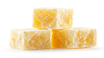 Close-up of three stacked yellow soap bars with a textured surface on a white background photo