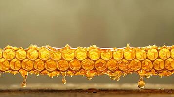 Close-up of golden honeycomb dripping with honey, showcasing the intricate hexagonal structure photo