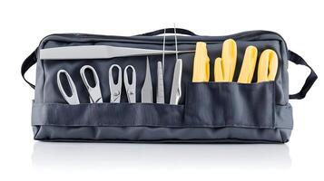 Professional sewing kit with assorted tools and scissors arranged neatly in a gray bag photo