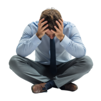 A sad man sits on the floor in a formal outfit, deeply distressed while holding his head in his hands, sad man is going through a crisis or is sick, file of isolated object on transparent background png