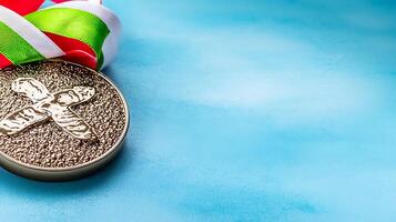 Silver medal with colorful ribbon on a smooth blue background, symbolizing achievement and victory photo