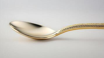 Close-up of a shiny golden spoon elegantly positioned against a soft gradient background photo